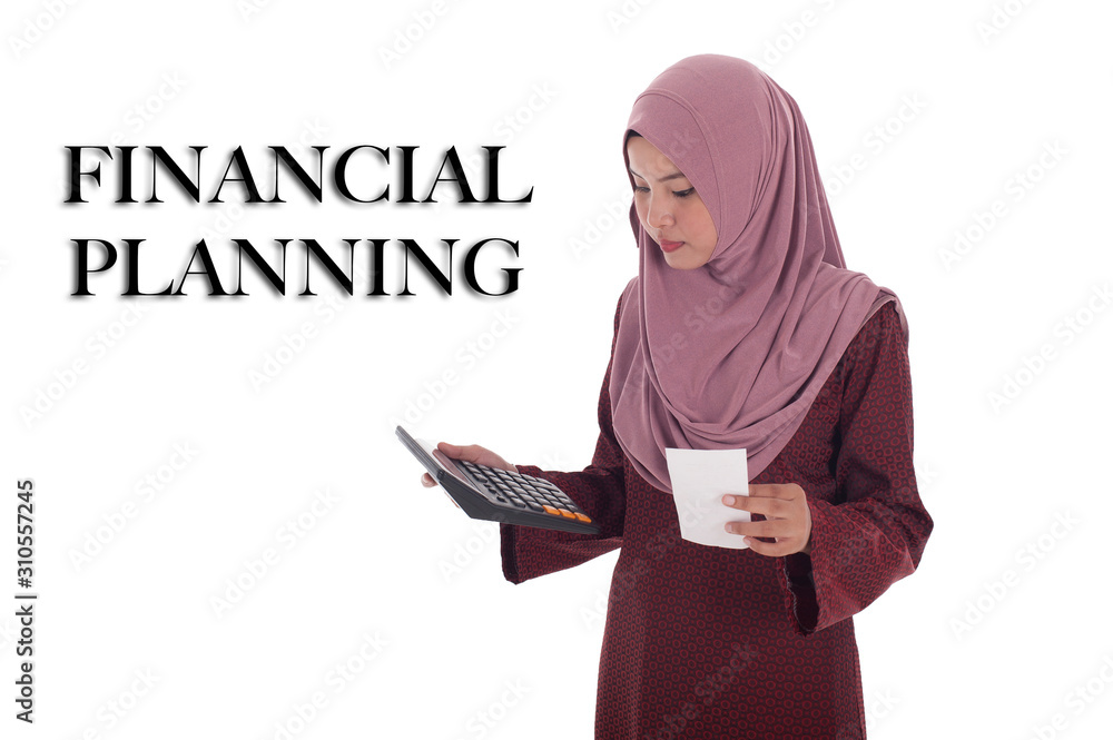 Attractive young muslimah businesswoman calculating her expanditure. Attractive young muslimah businesswoman calculating her expanditure.