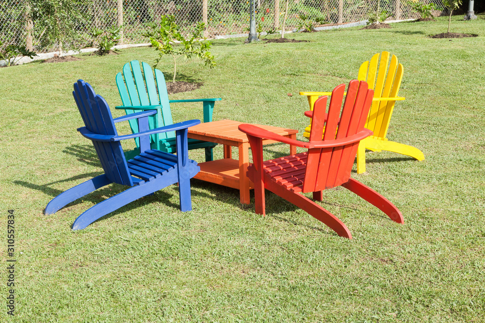 set of wooden chairs painted with vibrant colors; Photo in natural environment. set of wooden chairs painted with vibrant colors; Photo in natural environment.