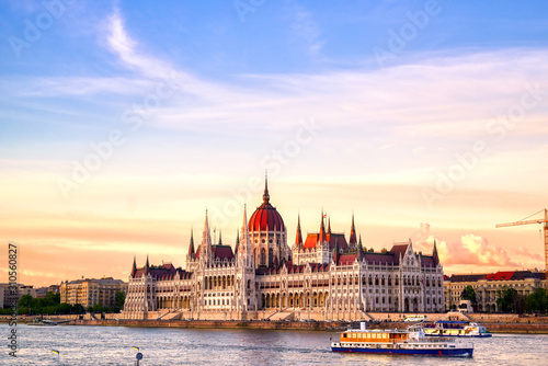 The Hungarian Parliament Building located on the Danube River in Budapest Hungary at sunset.