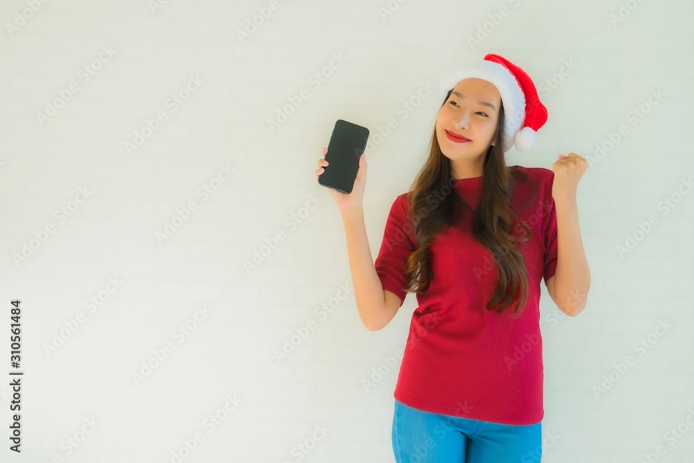 Portrait beautiful young asian women wear santa christmas hat with smart mobile phone Portrait beautiful young asian women wear santa christmas hat with smart mobile phone