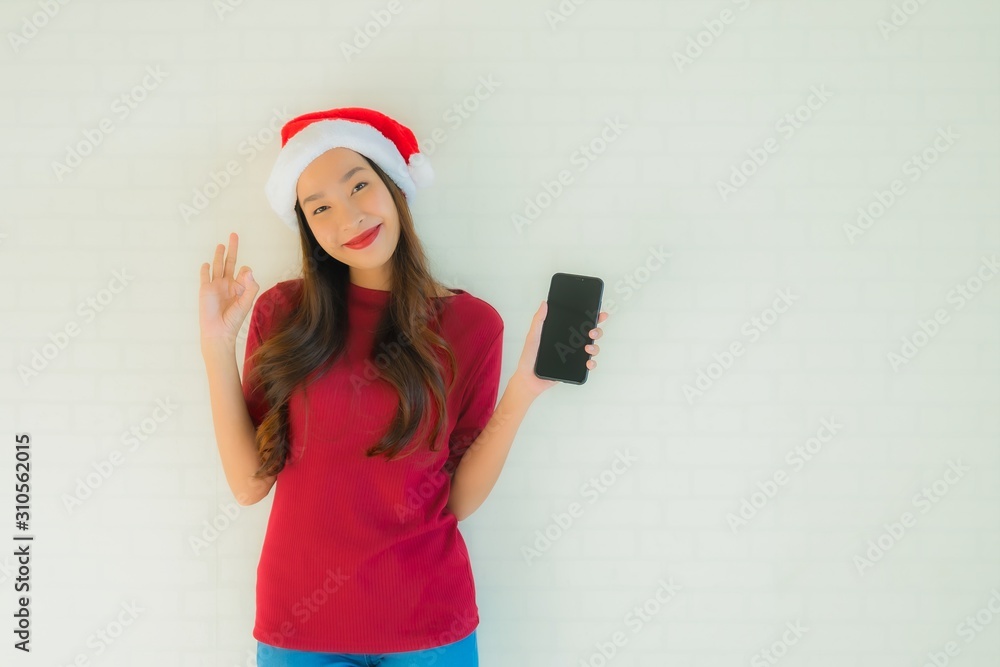 Portrait beautiful young asian women wear santa christmas hat with smart mobile phone Portrait beautiful young asian women wear santa christmas hat with smart mobile phone