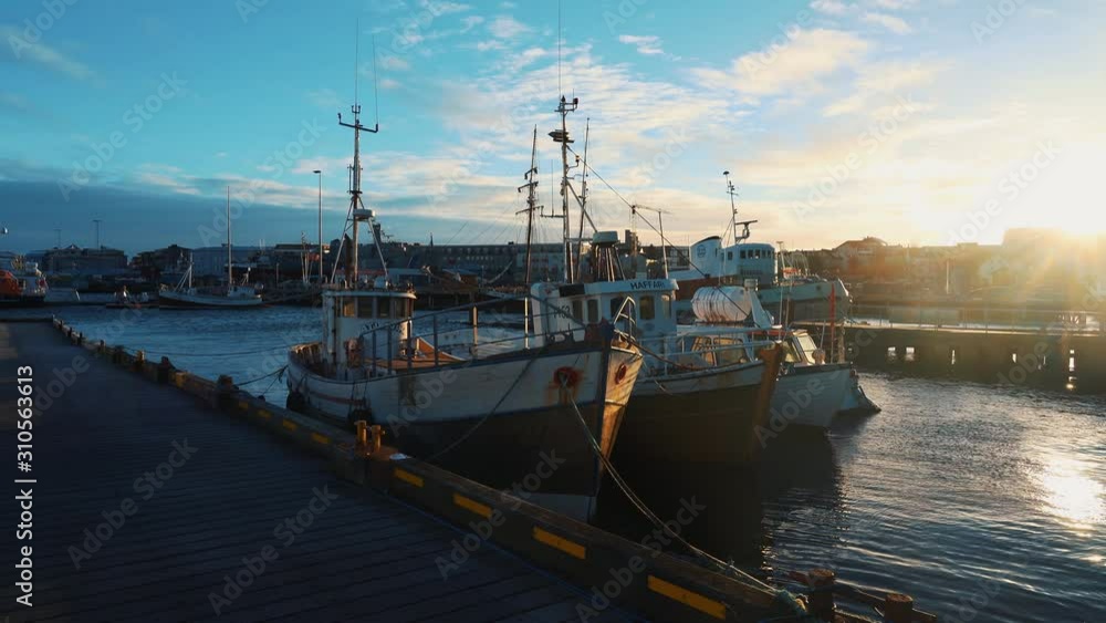Fisher boats are docked in pier in old harbor in small town, reykjavik, Iceland Fisher boats are docked in pier in old harbor in small town, reykjavik, Iceland