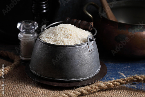 Close up white rice in measuring cup on table, Thai Jasmine rice in rustic kitchen background