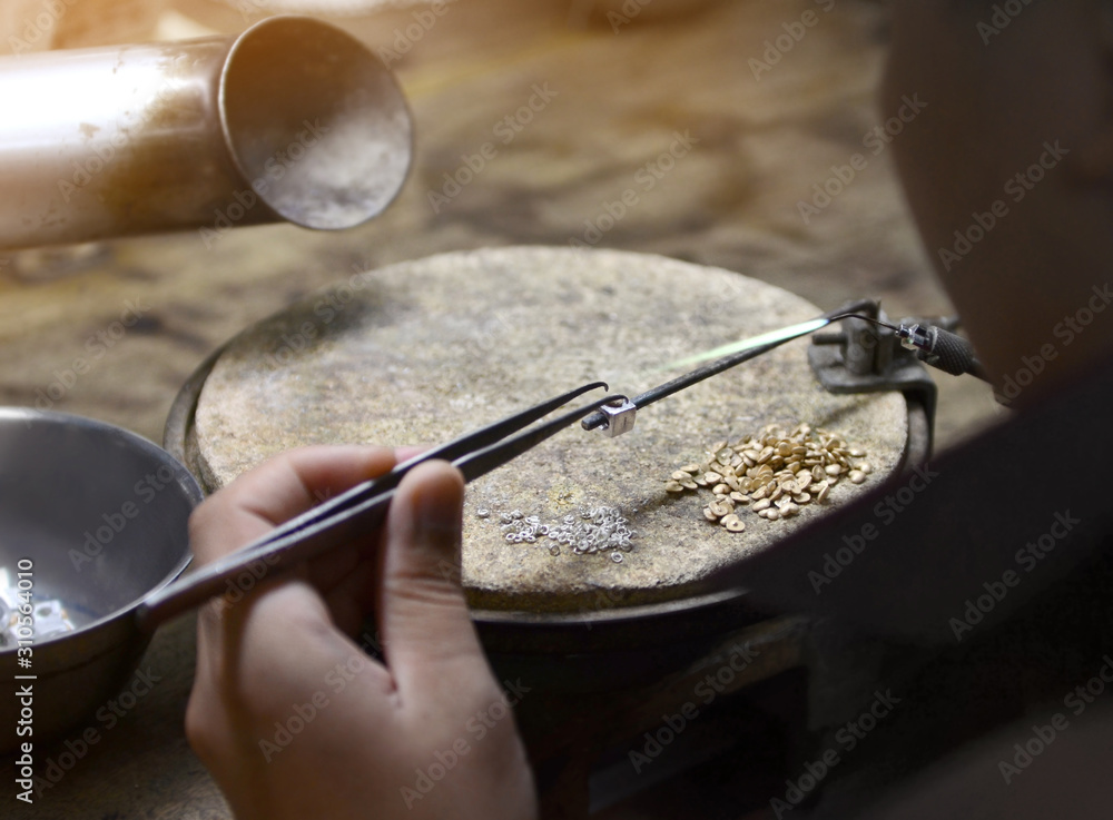 Goldsmith working jewelry process unfinished. Goldsmith working jewelry process unfinished.
