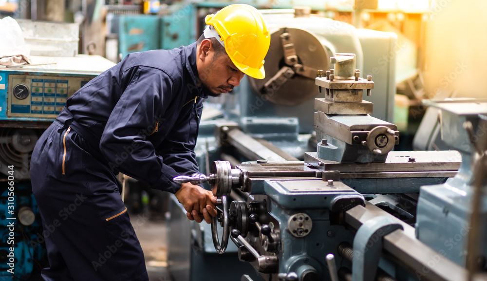 Factory Asian male worker. Asian man Lathe worker in production plant  drilling at machine on the factory. Yellow hard hat safety first at  mechanic factory. Stock Photo | Adobe Stock