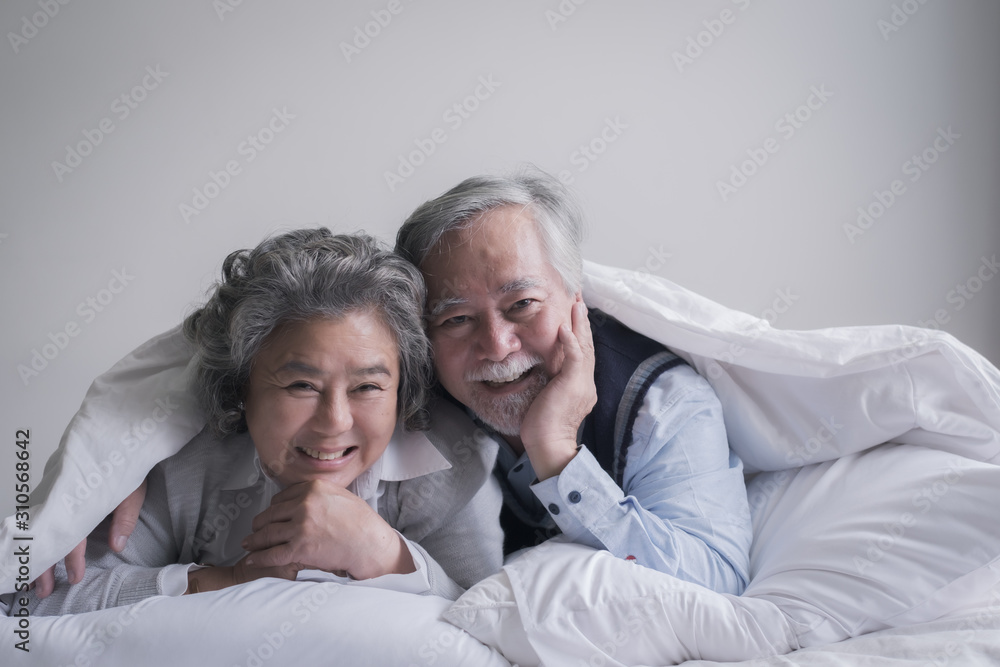 elderly couple caucasian senior man and woman sleep on bed and smiling in white blanket in bedroom, retirement health care with love lifestyle concept elderly couple caucasian senior man and woman sleep on bed and smiling in white blanket in bedroom, retirement health care with love lifestyle concept
