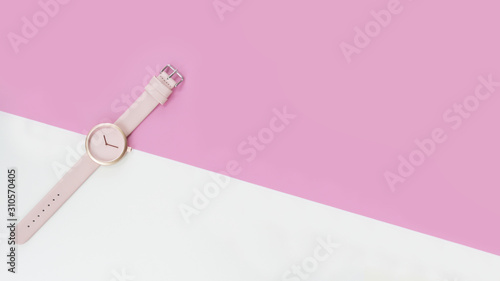 close up of pink wrist watches on pink and white background