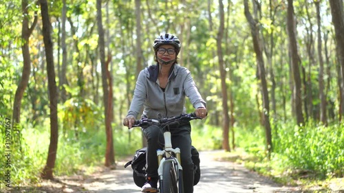 Senior asian woman riding bikes in park