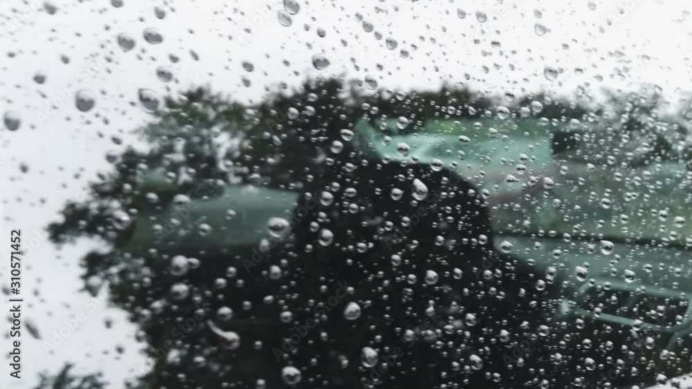 Close up shot moving along raindrops on the window of a car. Close up shot moving along raindrops on the window of a car.