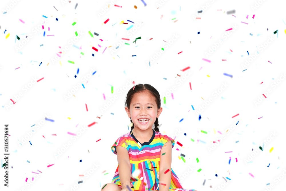Happy little child girl with colorful confetti on white background. Happy New Year or Congratulation Concept. - obrazy, fototapety, plakaty 