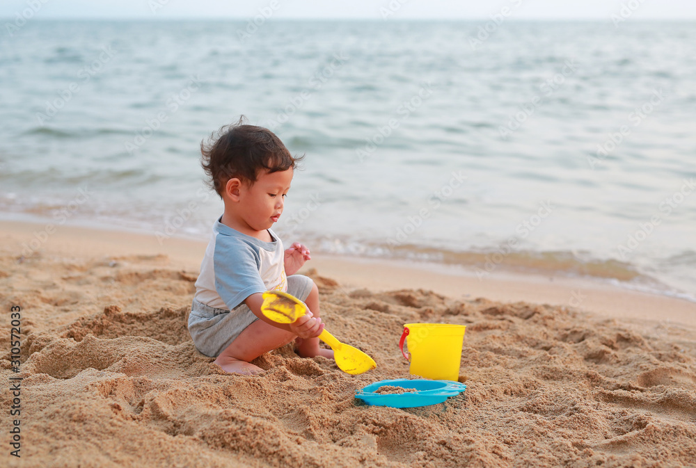 Little asian baby boy playing sand at beach alone. Little asian baby boy playing sand at beach alone.