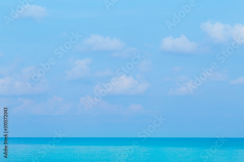 Fototapeta Naklejka Na Ścianę i Meble -  Floating clouds, fluffy colors against the blue sky and the sea