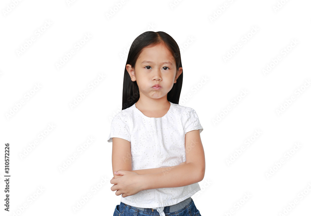 Portrait of an upset Asian little kid girl with arms folded and looking at camera isolated over white background. Person with Negative emotion concept. Portrait of an upset Asian little kid girl with arms folded and looking at camera isolated over white background. Person with Negative emotion concept.