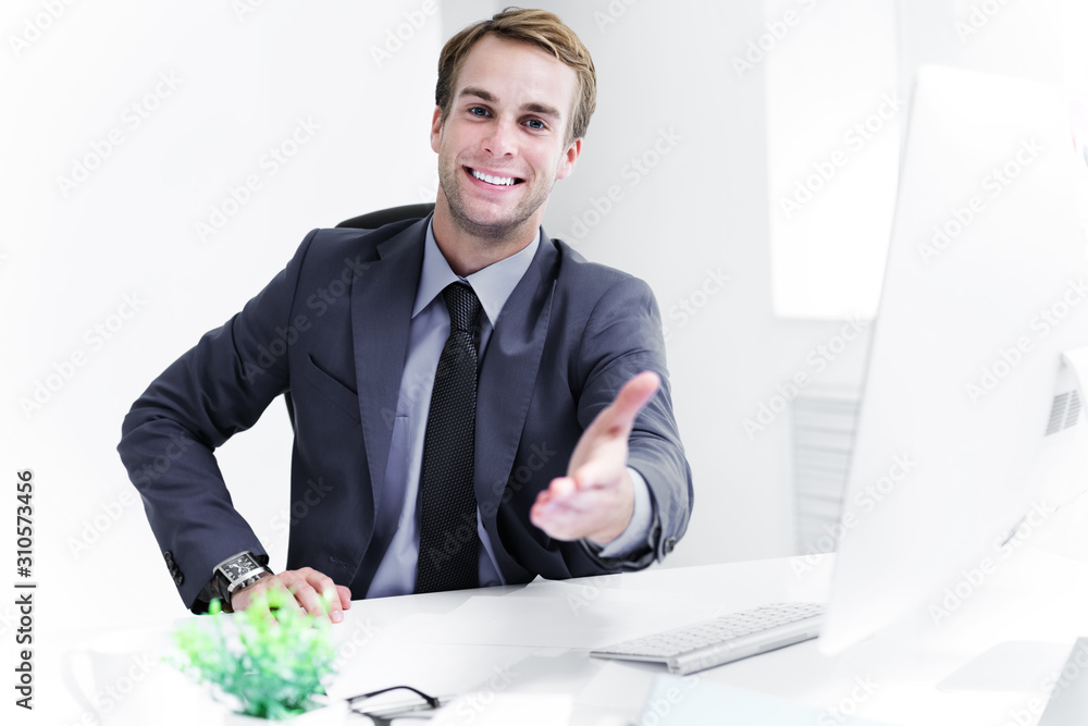 Portrait of young happy smiling businessman giving hand for handshake, in black confident style suit. Success in business, job and education concept shot. Portrait of young happy smiling businessman giving hand for handshake, in black confident style suit. Success in business, job and education concept shot.
