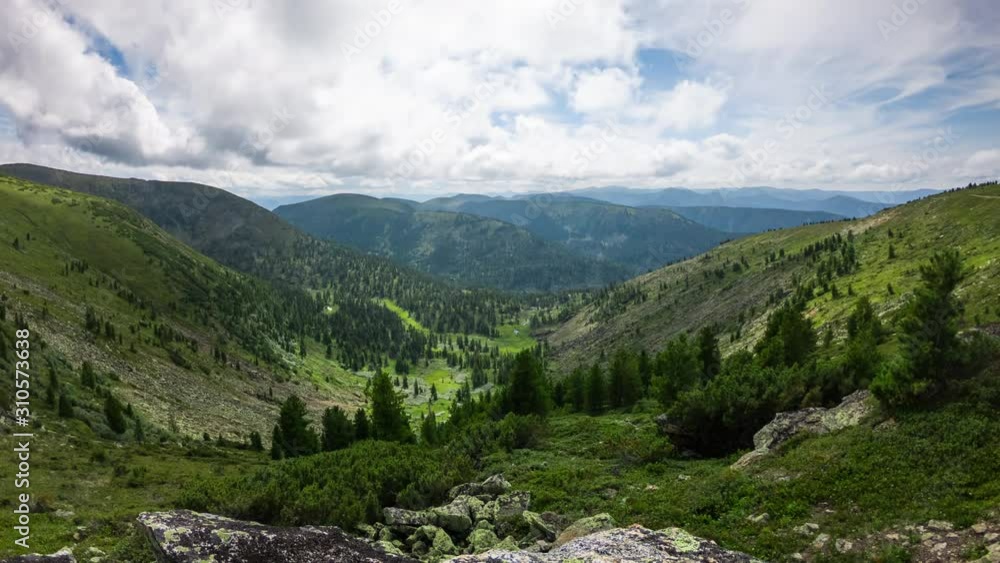 Scenic mountain view in sunny day. Beautiful mountainous landscape. Green valley with moves cloud shadows. Time lapse of amazing scenery Scenic mountain view in sunny day. Beautiful mountainous landscape. Green valley with moves cloud shadows. Time lapse of amazing scenery