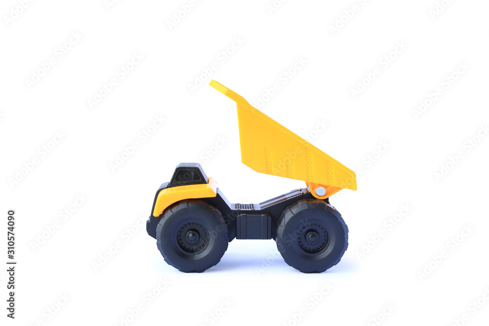 The yellow toy car Heavy truck isolated on white background. Children's tractor toy. Wheel loader construction car model. The yellow toy car Heavy truck isolated on white background. Children's tractor toy. Wheel loader construction car model.