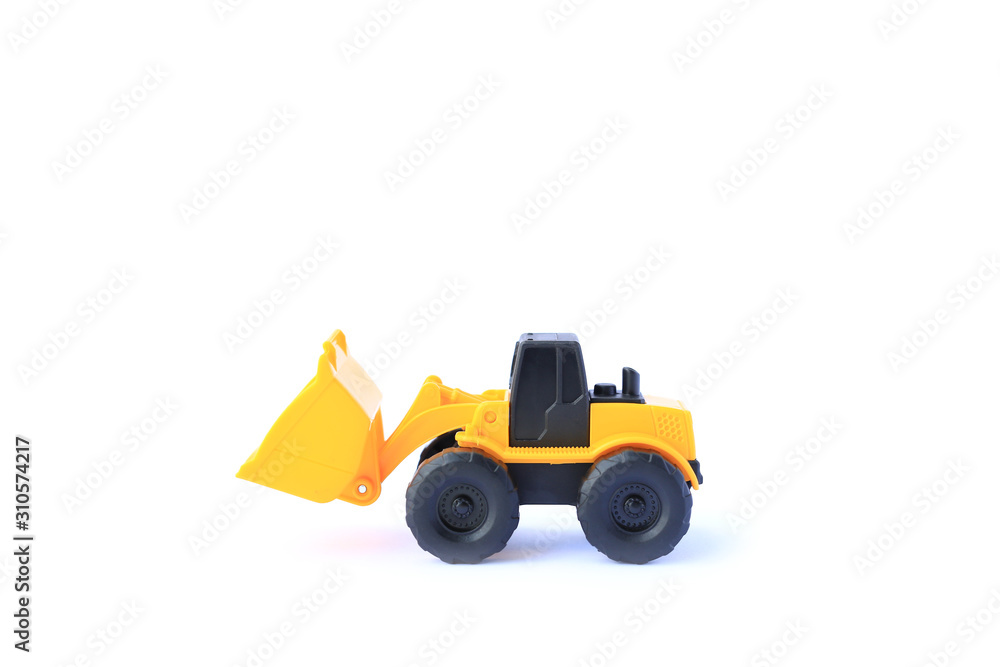 The yellow toy car Bulldozer isolated on white background. Children's tractor toy. Wheel loader construction car model.