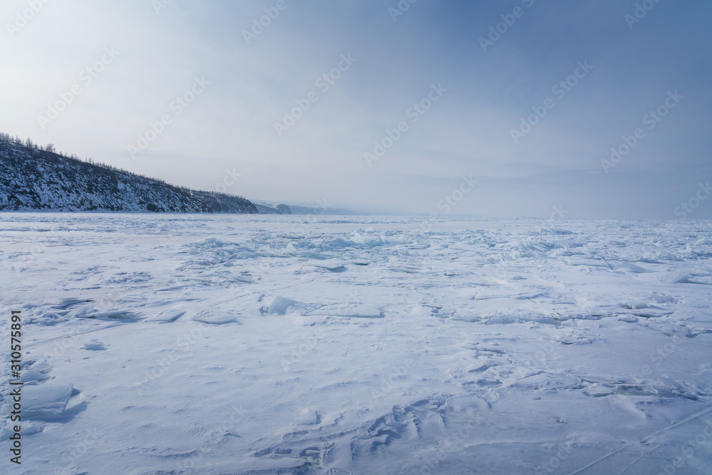 winter landscape with frozen Baikal lake and blue sky