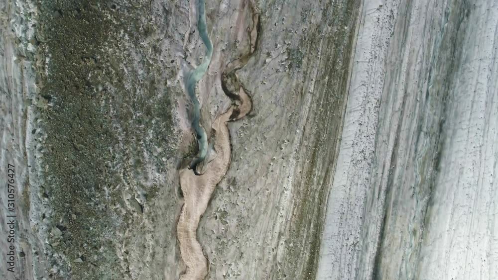 Drone fly high above downstream of glacial river on grooved Aktru glacier tongue Drone fly high above downstream of glacial river on grooved Aktru glacier tongue