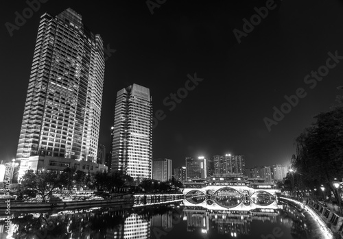 Night city view near the Anshun bridge in Chengdu  Sichuan  China. Black and white. Modern skyscrapers in Chinese metropolis city.