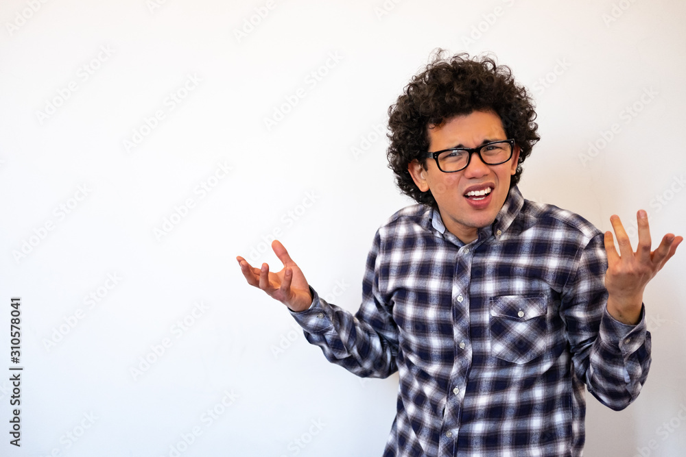 Fototapeta premium Latin American man looking confused, irritated, neutral background
