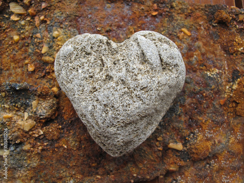 Single Heart Shaped Pebble On Rock photo