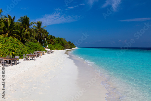Secluded private beach with tables and chairs