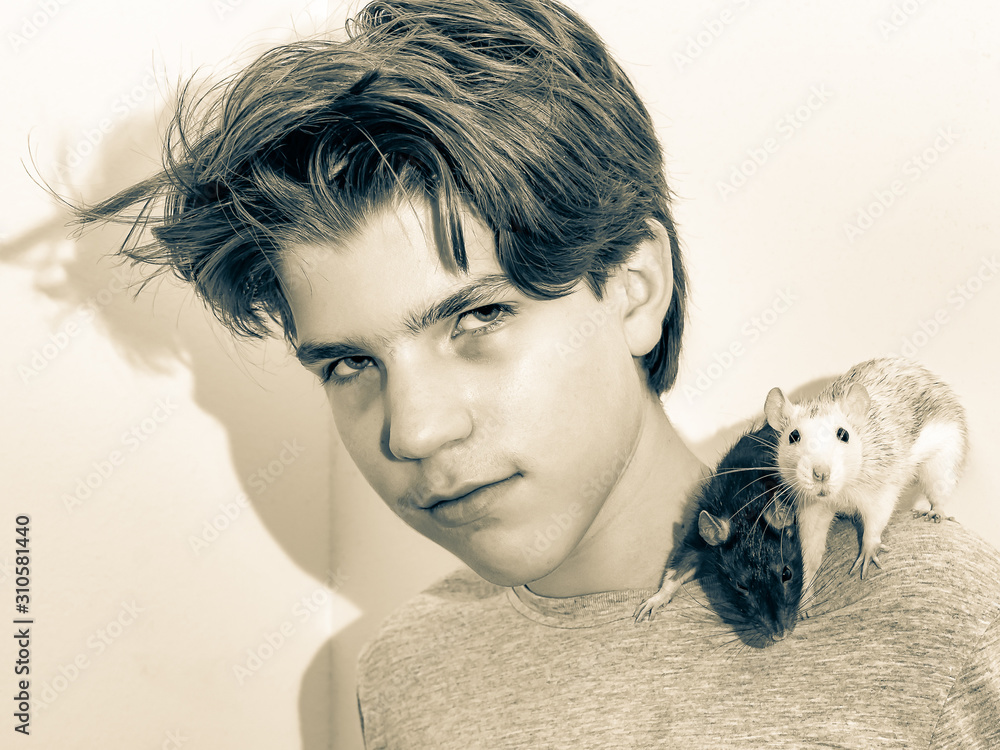 Young man carries his two pet rats on his shoulder Young man carries his two pet rats on his shoulder