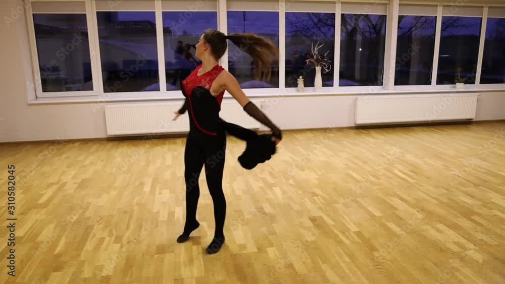 Slow motion professional female dancer performing on the dance floor Slow motion professional female dancer performing on the dance floor