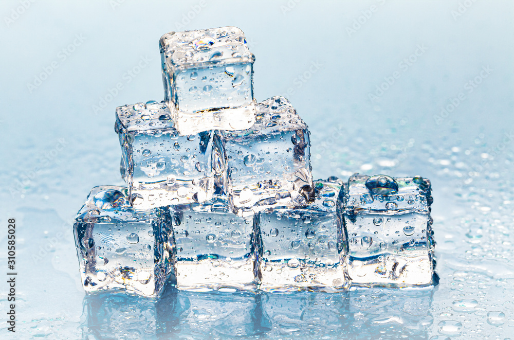 Square melting ice cubes on wet table Square melting ice cubes on wet table