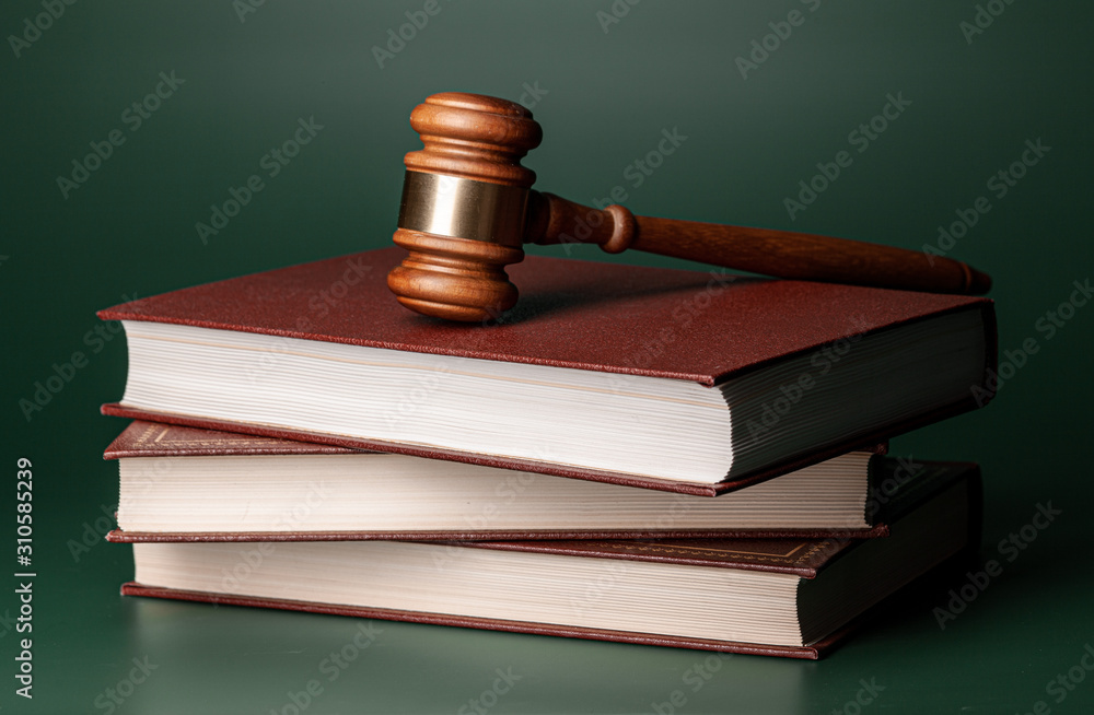 Close up of a brown wooden gavel and book Close up of a brown wooden gavel and book