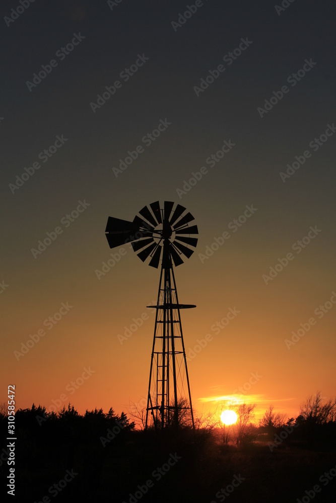 silhouette of windmill at sunset in Kansas. silhouette of windmill at sunset in Kansas.