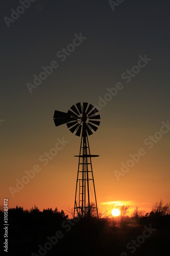 silhouette of windmill at sunset in Kansas.