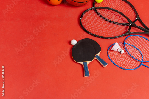Sport equipment flat lay. Variety of rackets and balls