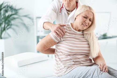 Doctor examining mature woman with joint pain in clinic © Pixel-Shot