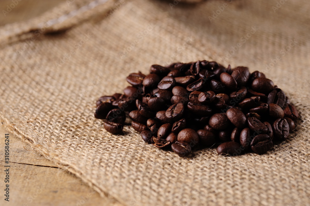 Heap of coffee beans on a jute sack Heap of coffee beans on a jute sack