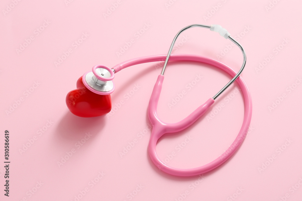 Stethoscope and red heart on color background. Cardiology concept Stethoscope and red heart on color background. Cardiology concept