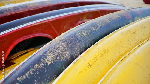 Beautiful view of colorful kayak or canoes at a beach