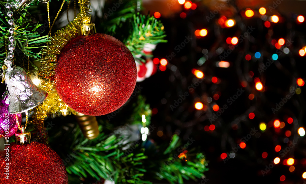red ball and Ornaments on christmas tree with bokeh of lights red ball and Ornaments on christmas tree with bokeh of lights