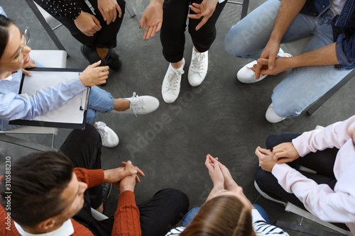 Psychotherapist working with patients in group therapy session, top view © New Africa