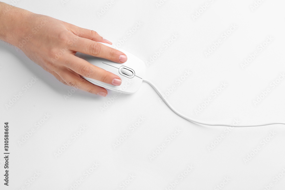Woman using modern wired optical mouse on white background, top view