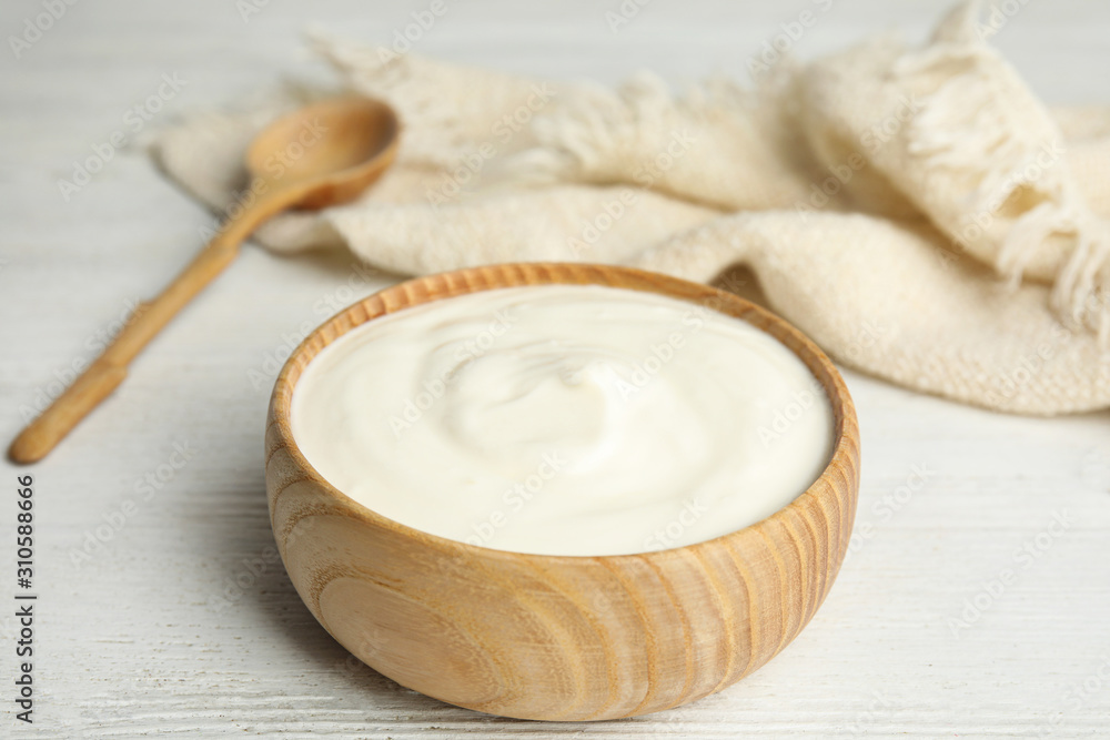 Tasty organic yogurt on white wooden table Tasty organic yogurt on white wooden table