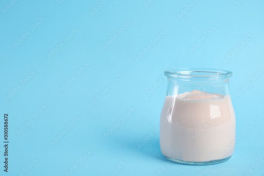 Tasty organic yogurt on light blue background. Space for text Tasty organic yogurt on light blue background. Space for text