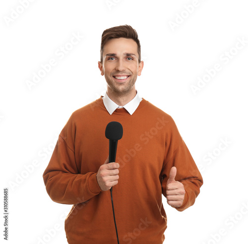 Young male journalist with microphone on white background