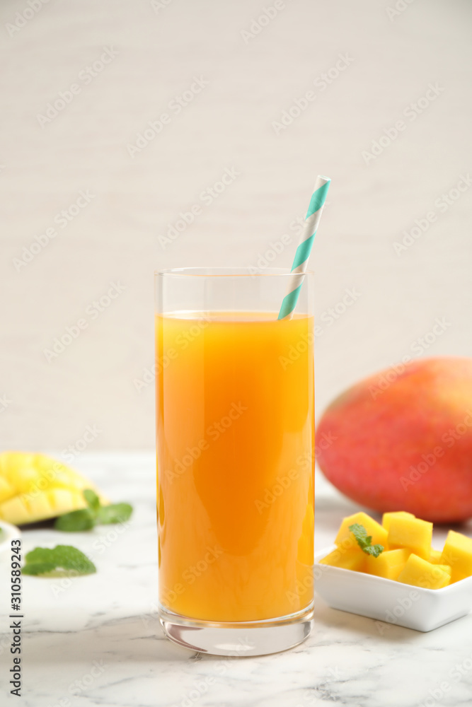Fototapeta premium Fresh delicious mango drink on marble table