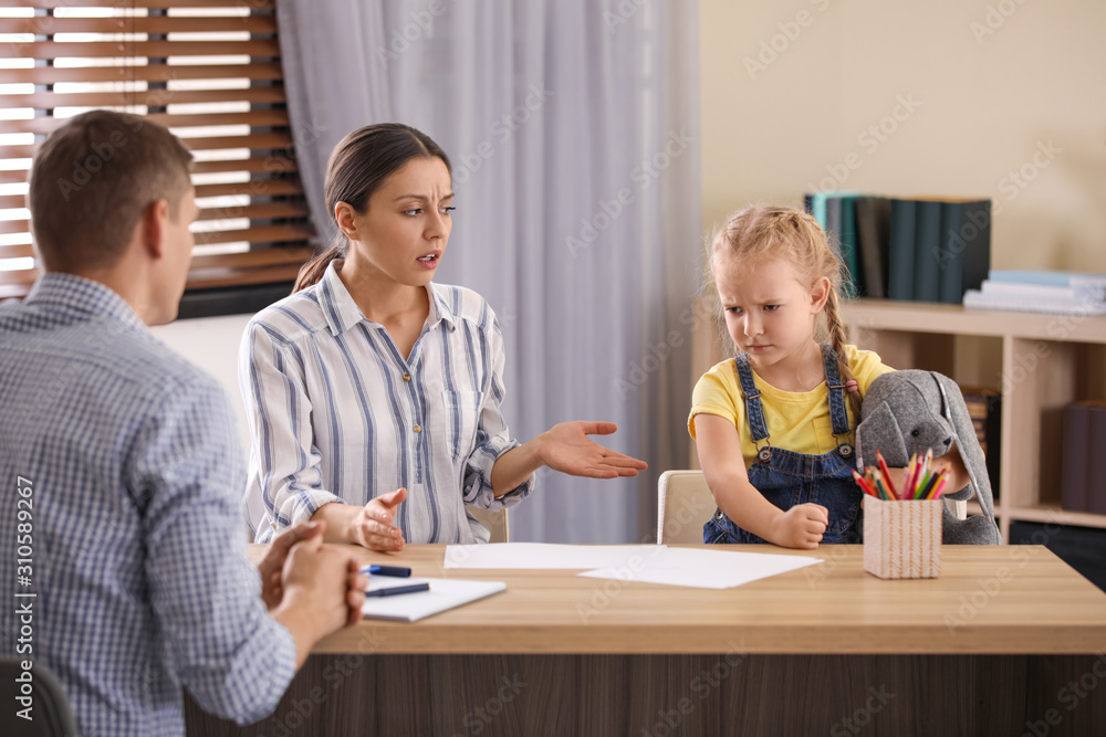 Child psychotherapist working with little girl and her mother in office Child psychotherapist working with little girl and her mother in office