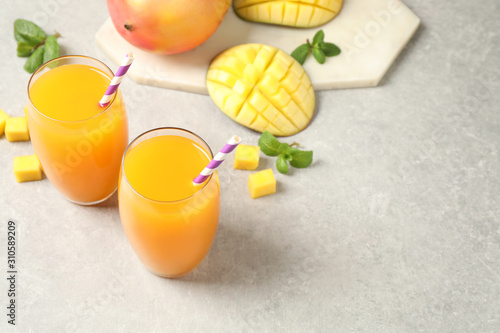 Fototapeta Naklejka Na Ścianę i Meble -  Fresh delicious mango drink on light table. Space for text
