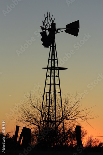 silhouette of windmill at sunset in Kansas north of Hutchinson out in the country.