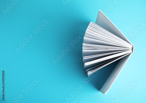 Canvas Print Hardcover book on blue background, top view. Space for text
