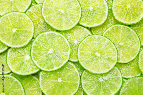 Many fresh juicy lime slices as background, top view © New Africa